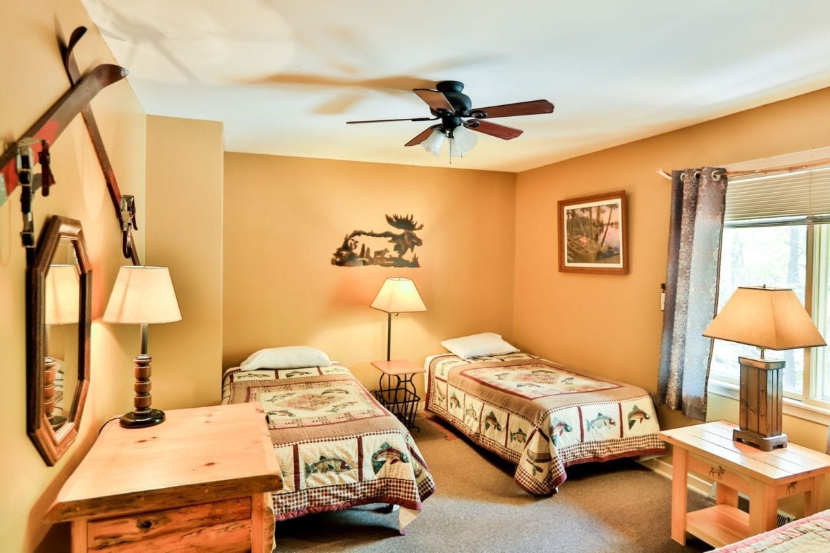 Moose lodge bedroom with two single beds.