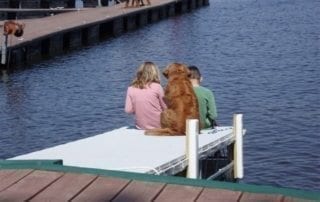 Kids and a dog on the dock.