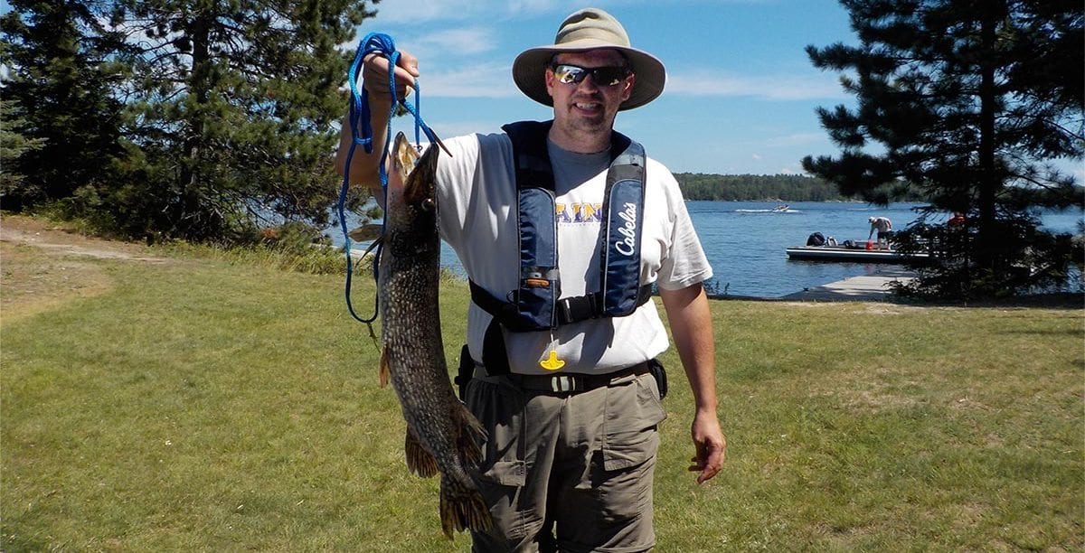 Jim holding a large northern pike.