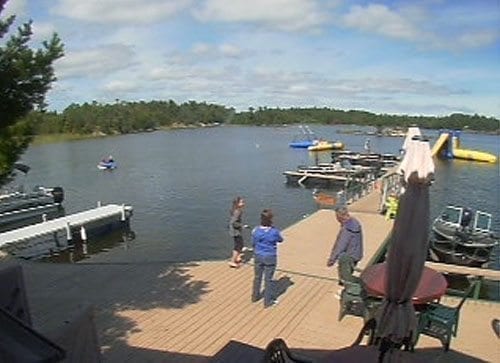 Webcam screenshot of guests on dock in summer.