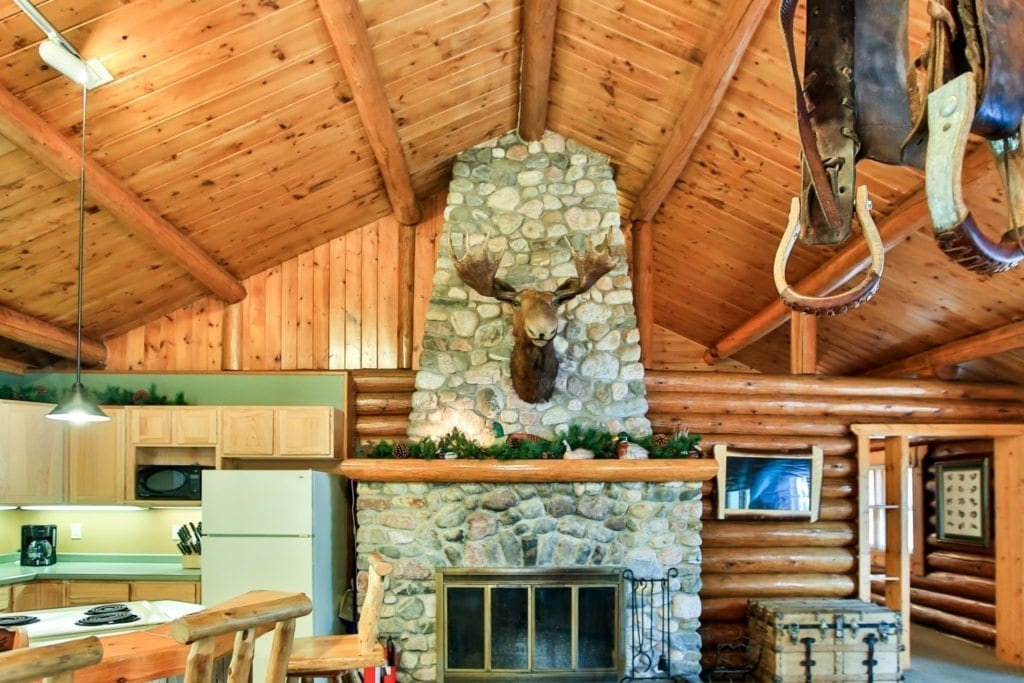 Firestone Log Lodge living room fireplace and kitchen.