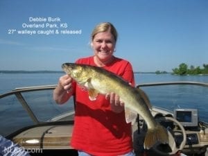 Debbie on a boat with 27" walleye.
