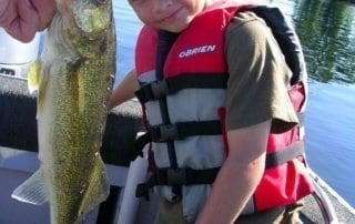Trent with a large fish on the boat.