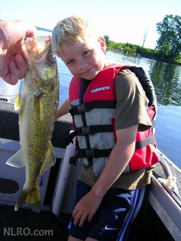 Trent with a large fish on the boat.