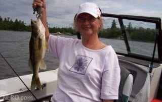 Woman holding a smallmouth bass.
