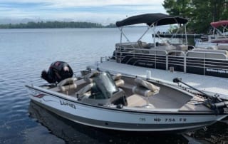 Lund fishing boat and pontoons on the dock.