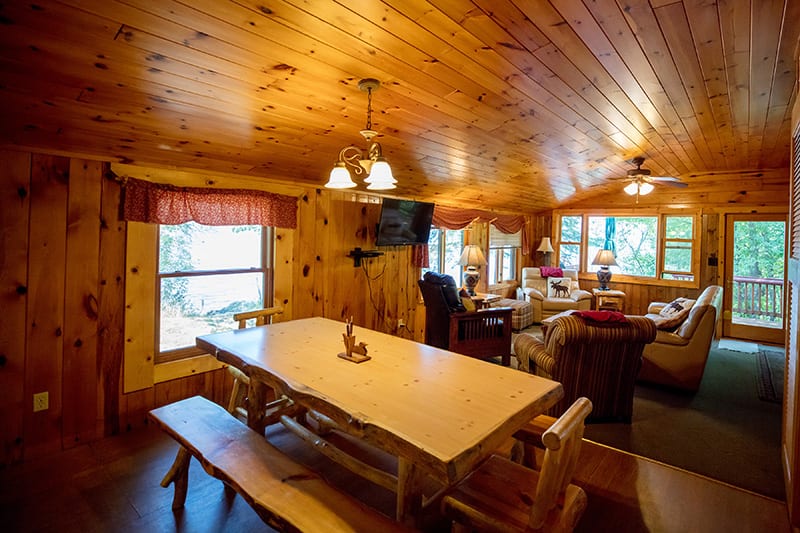 Moose Lodge dining table with benches and living room.