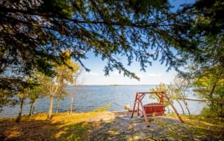 Moose Lodge Adirondack swing overlooking Lake Kabetogama at Northern Lights Resort