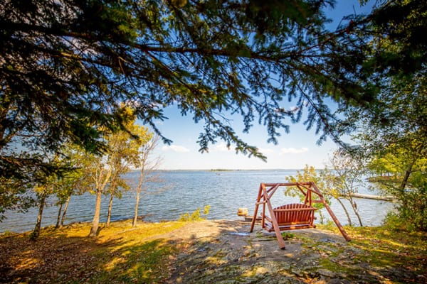 Moose Lodge Adirondack swing overlooking Lake Kabetogama at Northern Lights Resort
